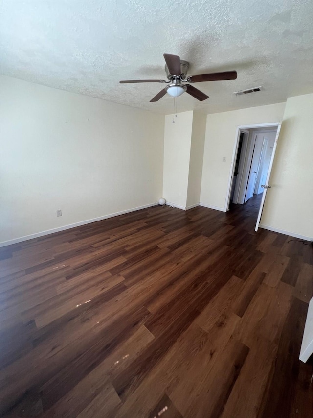 spare room featuring a textured ceiling, dark hardwood / wood-style flooring, and ceiling fan