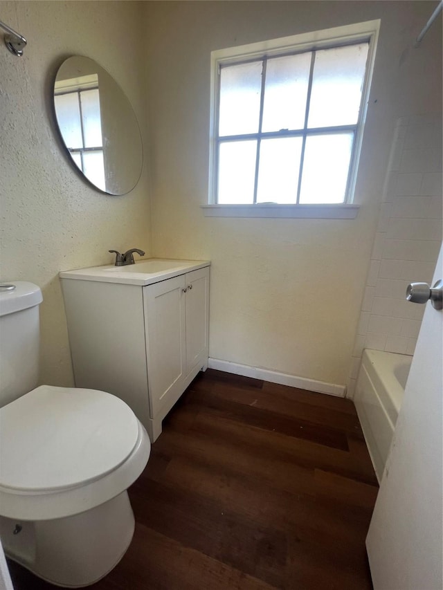 bathroom with vanity, hardwood / wood-style flooring, and toilet