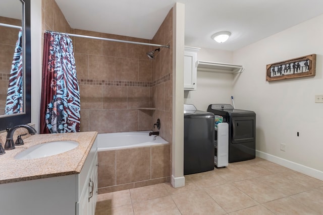 bathroom featuring tile patterned flooring, vanity, washer and clothes dryer, and shower / tub combo