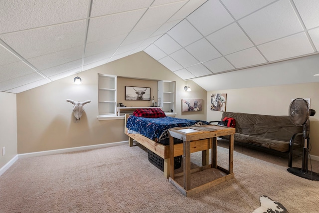 bedroom featuring a drop ceiling, vaulted ceiling, and carpet