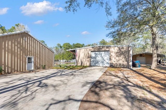 view of outdoor structure featuring a garage and a carport