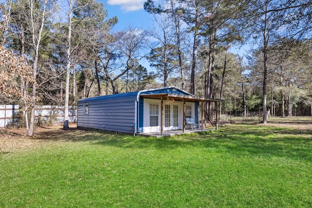 exterior space featuring french doors and a lawn