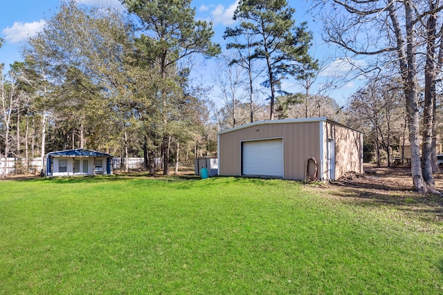 view of yard with a garage and an outdoor structure