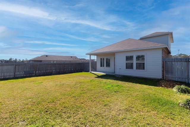 rear view of property with a yard