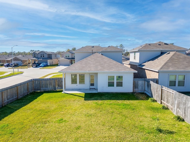 back of property with a patio area and a lawn