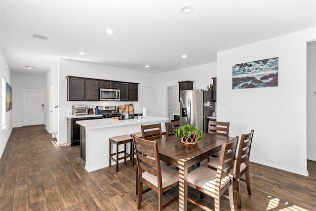 dining area featuring sink and dark hardwood / wood-style floors