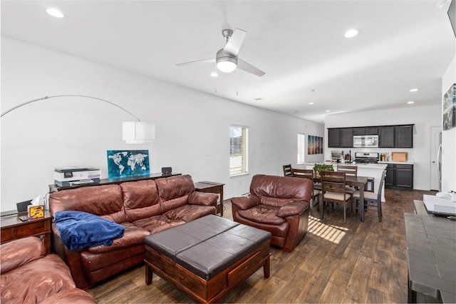 living room with ceiling fan and dark wood-type flooring