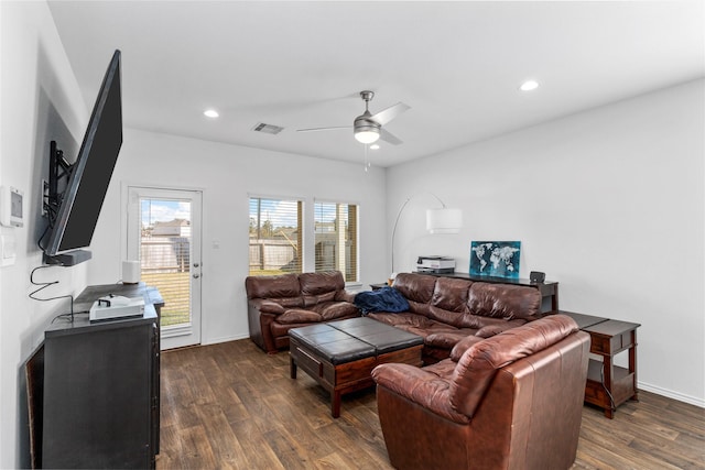 living room featuring dark hardwood / wood-style floors and ceiling fan