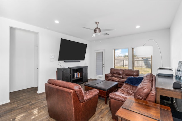 living room featuring ceiling fan and dark hardwood / wood-style flooring