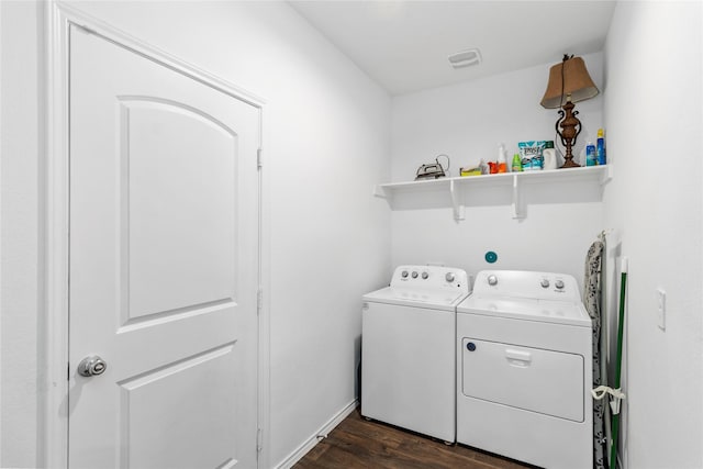 washroom featuring dark hardwood / wood-style floors and washing machine and clothes dryer