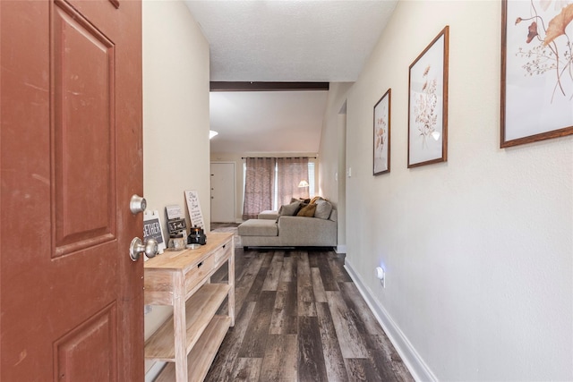 hallway with dark hardwood / wood-style floors and a textured ceiling