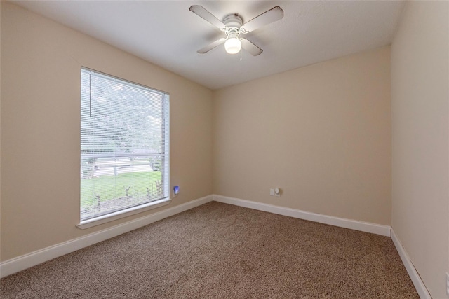 carpeted empty room featuring ceiling fan