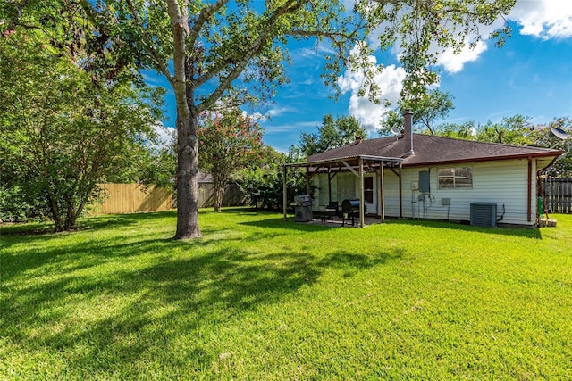 exterior space with a patio area, central air condition unit, and a lawn