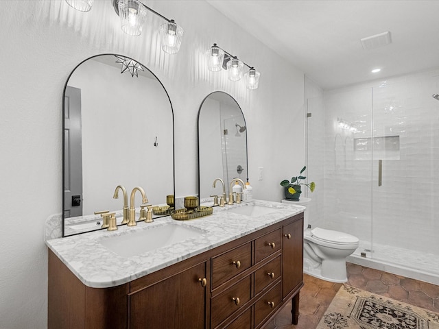 bathroom with toilet, a shower with shower door, tile patterned floors, and vanity