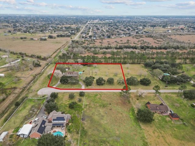 birds eye view of property with a rural view