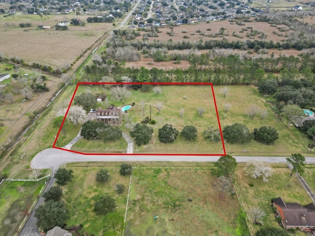 birds eye view of property with a rural view