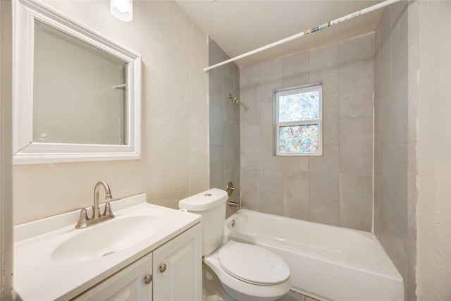 full bathroom with vanity, toilet, and tiled shower / bath combo