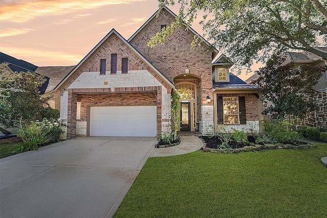 view of front facade with a lawn and a garage