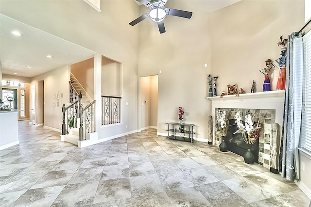 interior space featuring ceiling fan and a fireplace