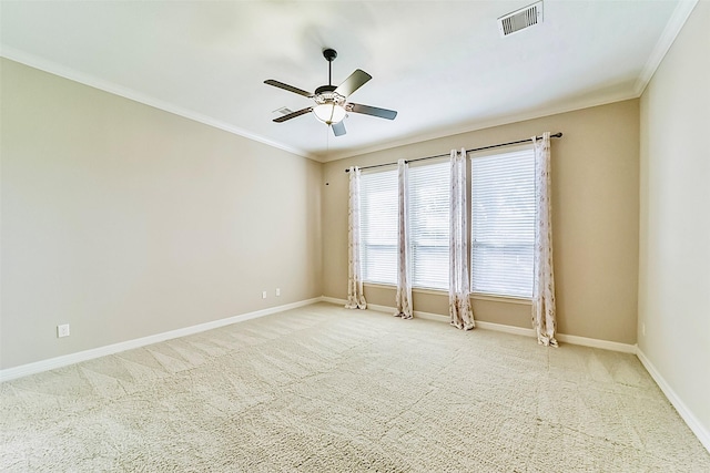 carpeted empty room with ceiling fan and crown molding