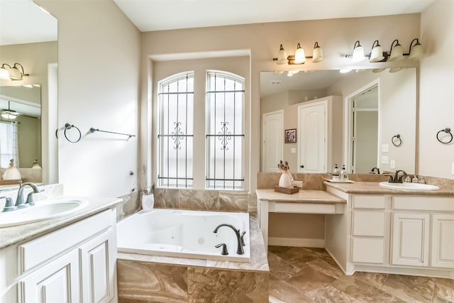 bathroom with vanity and tiled bath