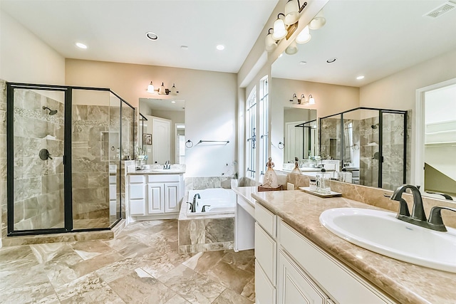 bathroom with vanity and separate shower and tub