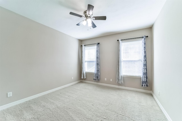 carpeted spare room featuring ceiling fan