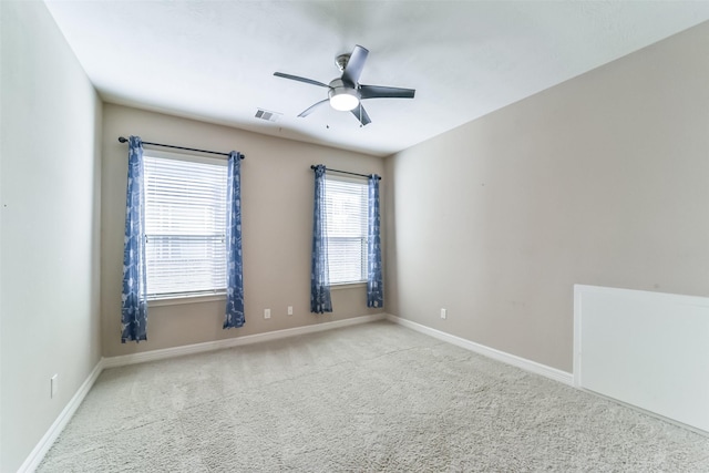 unfurnished room featuring ceiling fan and light colored carpet