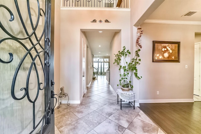 tiled entryway with crown molding