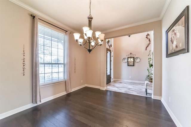 interior space with dark hardwood / wood-style floors, ornamental molding, and an inviting chandelier