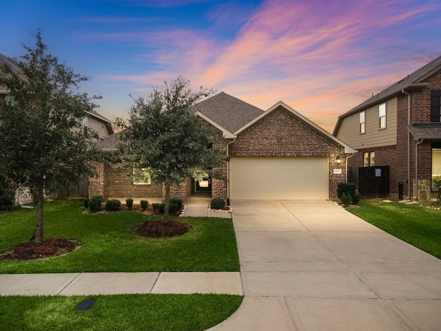 view of front of property with a yard and a garage