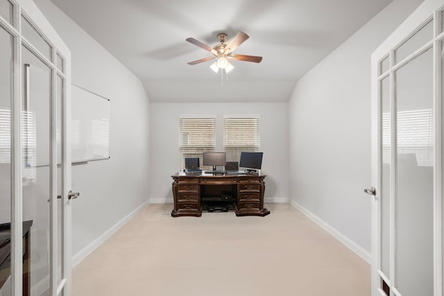 office featuring ceiling fan, light carpet, and lofted ceiling