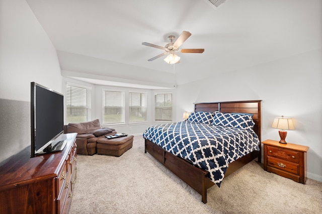 bedroom featuring lofted ceiling, light colored carpet, and ceiling fan