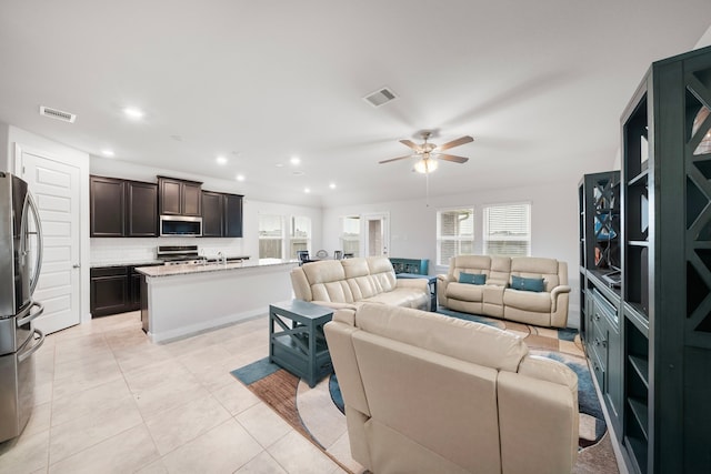 living room with light tile patterned floors and ceiling fan