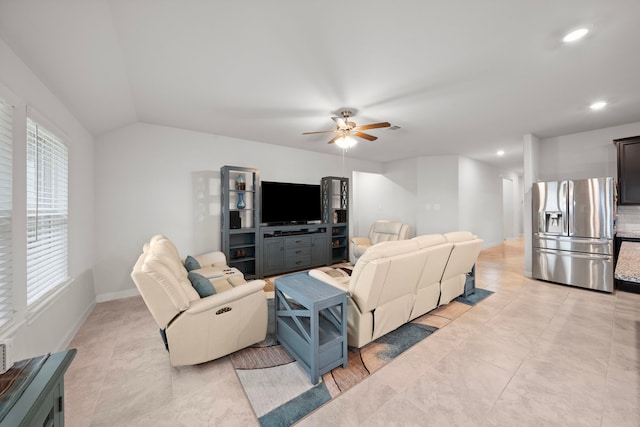 living room with ceiling fan and vaulted ceiling