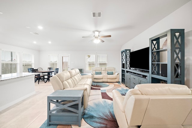 living room featuring ceiling fan, plenty of natural light, and light tile patterned floors