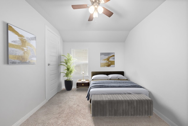 bedroom featuring vaulted ceiling, light carpet, and ceiling fan