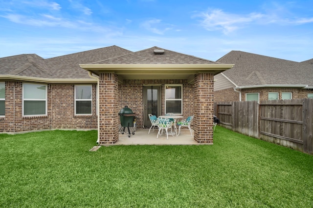 back of house with a lawn and a patio area