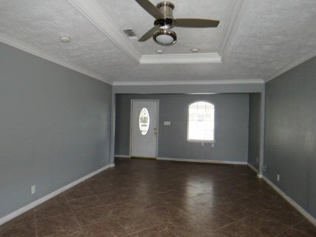 foyer entrance featuring a textured ceiling, a raised ceiling, ceiling fan, and crown molding