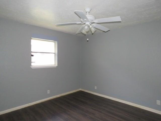 unfurnished room featuring ceiling fan and dark hardwood / wood-style floors