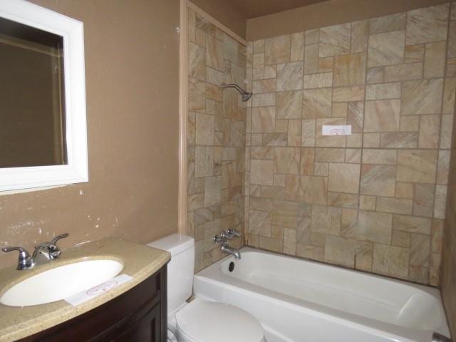 full bathroom featuring vanity, toilet, and tiled shower / bath