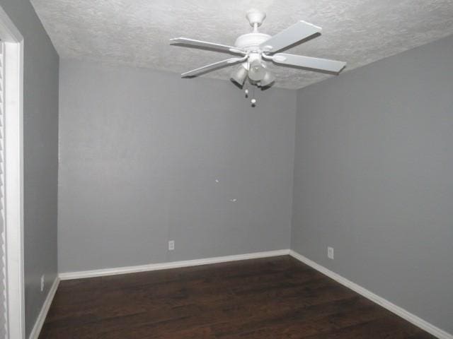 unfurnished room featuring dark hardwood / wood-style flooring, a textured ceiling, and ceiling fan