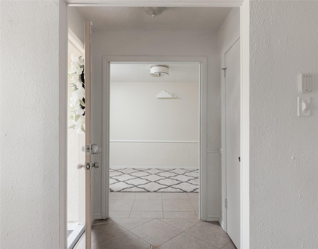 corridor with light tile patterned floors