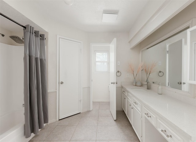 bathroom featuring tile patterned flooring, shower / bath combination with curtain, vanity, and a textured ceiling