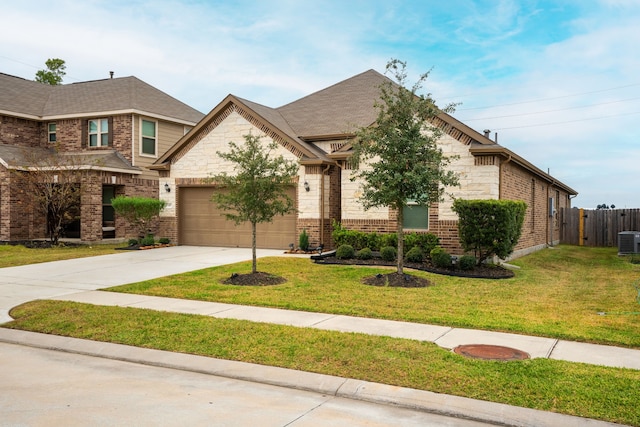 view of front of property featuring a garage, central air condition unit, and a front yard