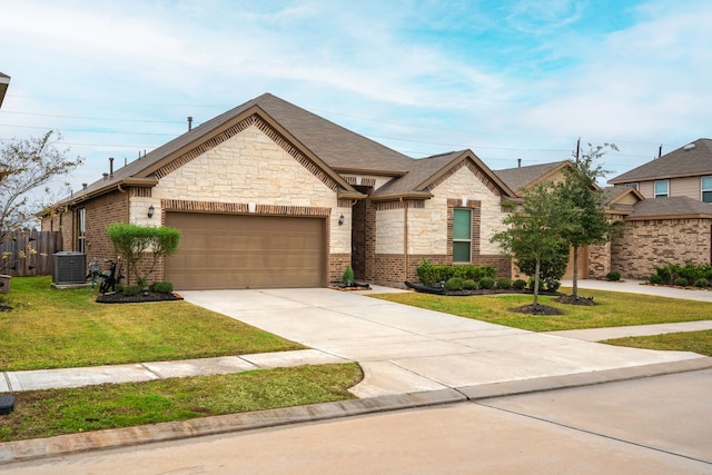 view of front of house with cooling unit, a garage, and a front lawn