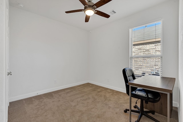 office space featuring light carpet and ceiling fan