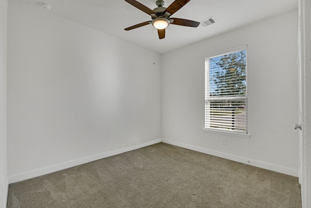 empty room with carpet flooring, ceiling fan, and a healthy amount of sunlight