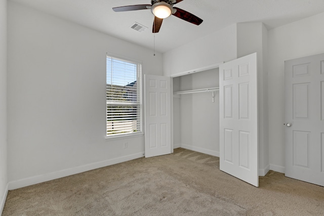 unfurnished bedroom with light carpet, a closet, and ceiling fan