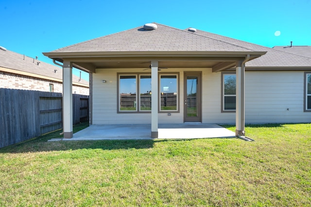 back of house with a patio area and a yard